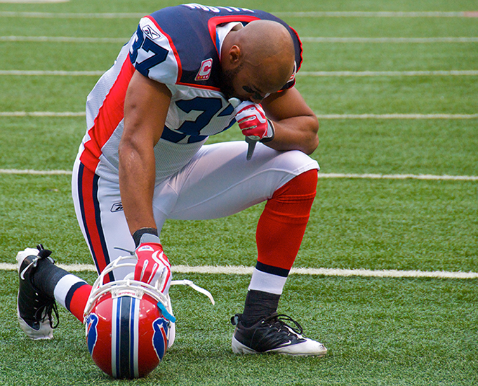 George Wilson of the Buffalo Bills praying on the field in October 2009