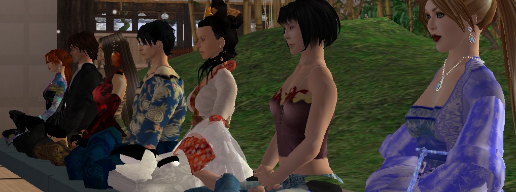 a group of Second Life avatars sit together meditating