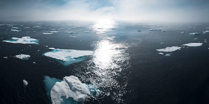 Ocean, broken ice, and a sunset off the coast of Greenland
