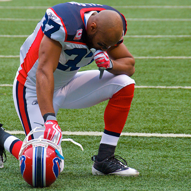 George Wilson of the Buffalo Bills praying on the field in October 2009