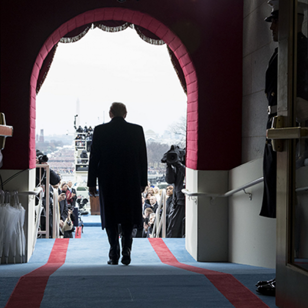 Shot from behind him, Trump walking out from the capitol building to being inaugurated as president on Jan 20, 2017.
