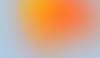 abstract image of a yellow and orange circle blurring into a light blue background