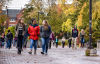 students walking along campus courtyard on a fall day