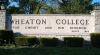 Concrete and stone sign for Wheaton College on campus. It reads "Wheaton College" and "For Christ and His Kingdom"
